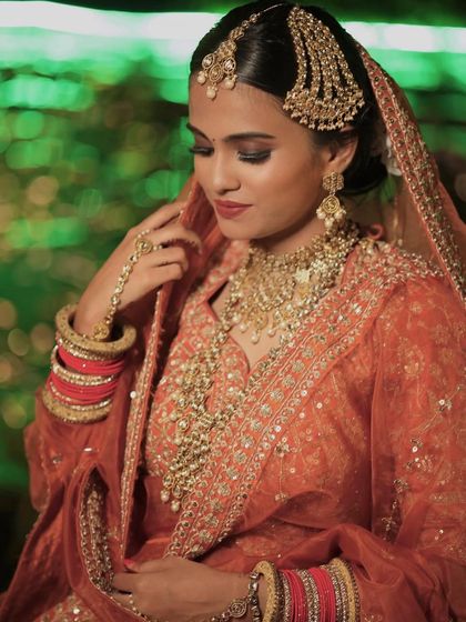The intricate details of the bridal jewelry and makeup are captured here. I ensure that every element works in harmony to create a cohesive look.