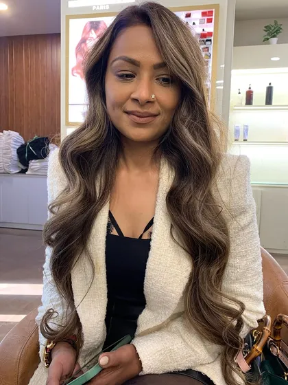 The client is glowing with her new hot ash brown hair color. The waves and highlights are perfectly styled.
