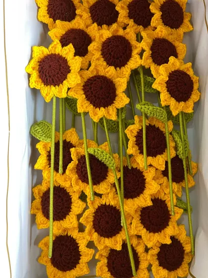 A box filled with bright sunflower stems, part of a large weekly dispatch.
