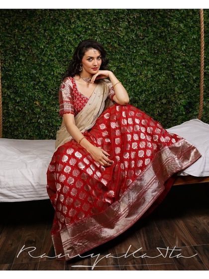 The silver buti work on the red Benaras silk catches the light beautifully, creating a luxurious texture that is both seen and felt.