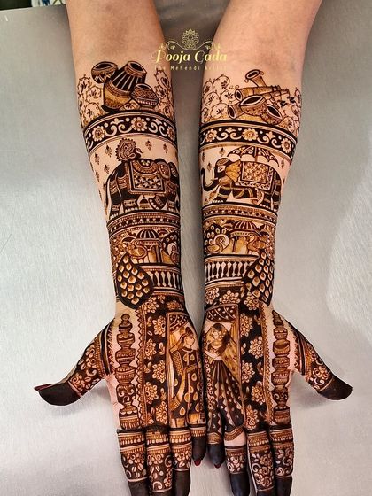 A closer look at the intricate details of the bridal design, showing the bride and groom portraits and the beautifully rendered elephants.