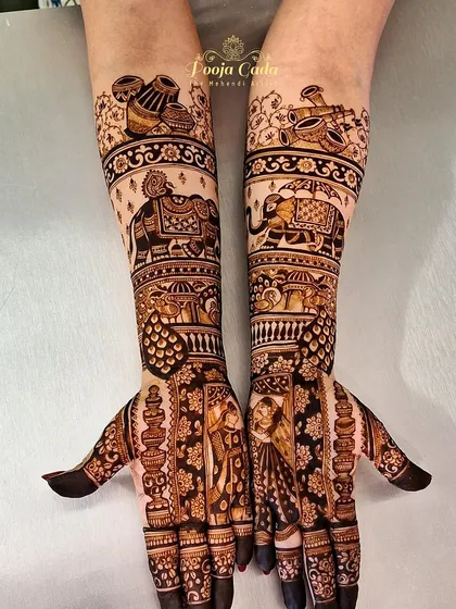 A closer look at the intricate details of the bridal design, showing the bride and groom portraits and the beautifully rendered elephants.