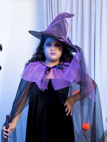A close-up portrait focusing on the upper part of the witch costume and the model's themed makeup. This detailed shot is excellent for social media or as a secondary image in an e-commerce gallery to highlight product quality and styling possibilities.