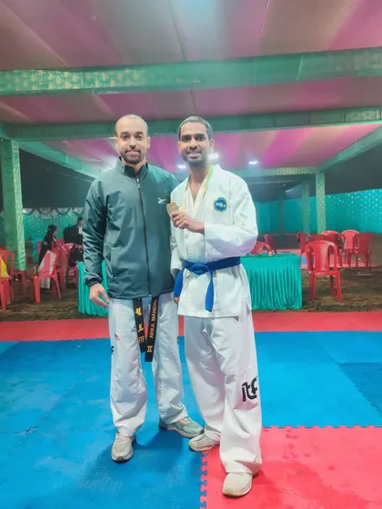 Posing with a fellow instructor and a student who won a medal at the national championship. Mentorship is key to building a successful team.