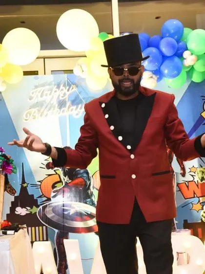 Posing in front of an incredible superhero backdrop. I love when the party theme is full of action and adventure, and I bring that same energy to my magic show.