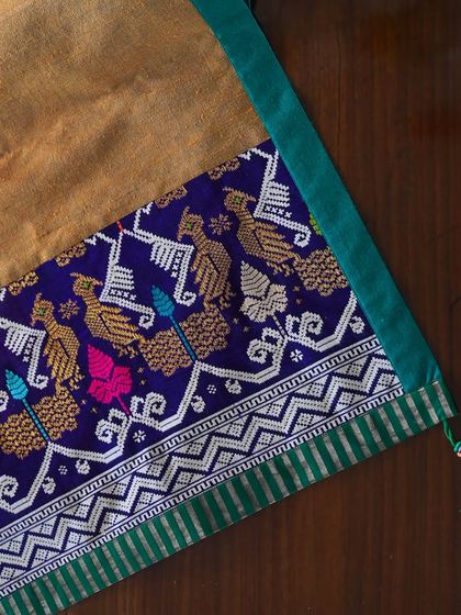 A close-up of a runner featuring a stunning woven border with a peacock motif, likely from a vintage silk sari. The detail and color are exceptional.
