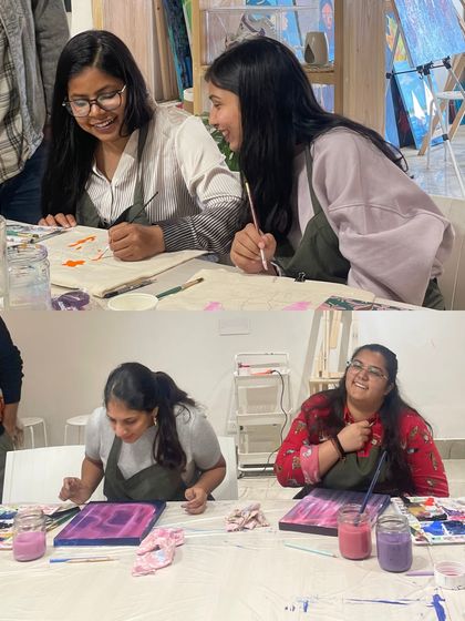 Laughter is a key ingredient in our team bonding workshops. These colleagues are sharing a fun moment while working on their individual art projects side-by-side.