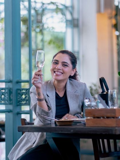 A toast to good times. A guest raises her champagne flute, celebrating a special moment at my crafthouse.