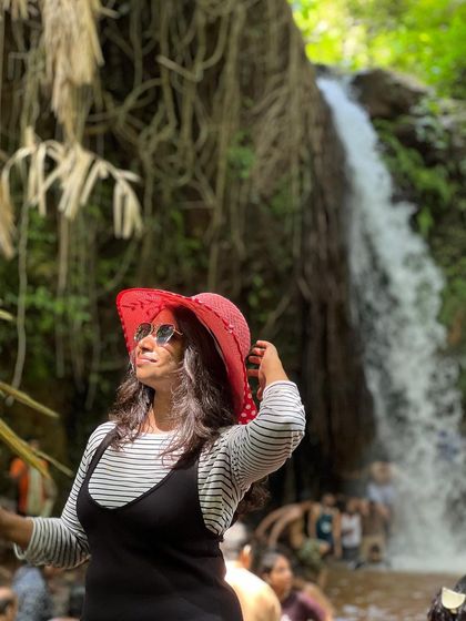 A trekker enjoying the view at a waterfall near Yaana.