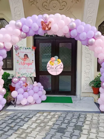 A delicate pastel pink and purple balloon arch framing an entrance, perfect for a princess or butterfly-themed party.