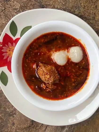 An everyday Red Fish Curry, a staple in any Kerala home. Here, it's served with Pidi, or steamed rice dumplings, for a comforting and traditional lunch.