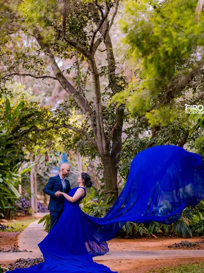 A romantic dance in a garden pathway, with the flowing blue dress adding a touch of magic.