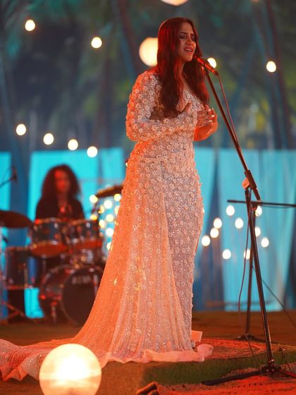 Another angle of Nikhita Gandhi's performance look, showing how the elegant gown moved and caught the light on stage.