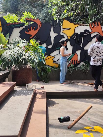 A work-in-progress shot of the outdoor metal installation, showing me and my team on-site, planning the arrangement of the colorful abstract pieces.