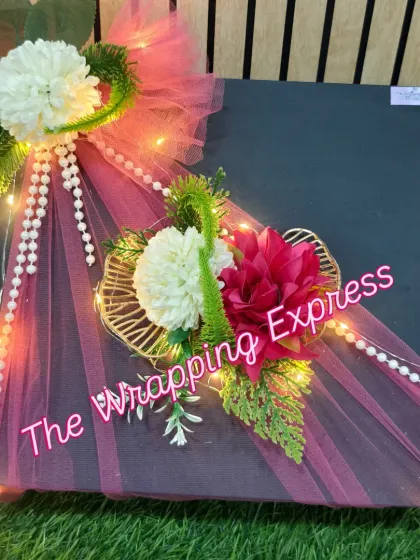 The finished surprise gift box, with its elegant floral and pearl decorations. The warm fairy lights make it perfect for an evening celebration.