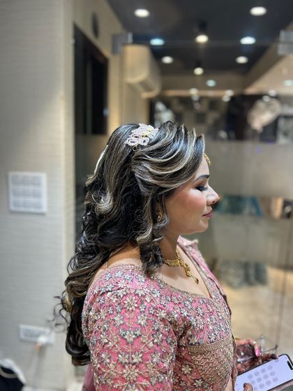 A side profile of the client, showing how the curly hairstyle frames her face.