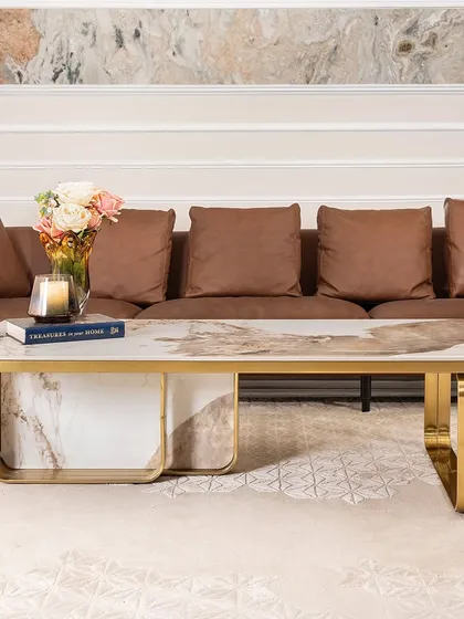 A closer look at the spectacular patterns in the artificial marble top of this rectangular coffee table. The gold-accented stainless steel frame provides a sturdy and luxurious foundation, making it a perfect fit for a modern living room.