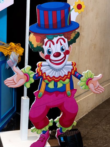A life-sized, friendly clown prop that welcomes guests to the party.