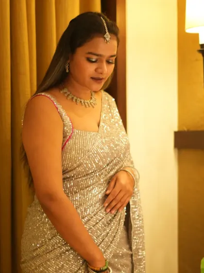 A demure, downward glance, highlighting the necklace and the shimmer of the saree. A versatile shot for both commercial and editorial use.