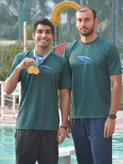 Aaryan Bhosale with Coach Virdhawal Khade after a successful championship. We foster a close working relationship between our coaches and swimmers.
