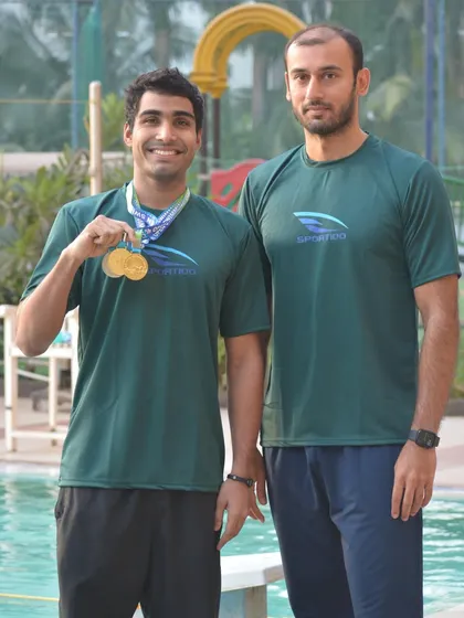 Aaryan Bhosale with Coach Virdhawal Khade after a successful championship. We foster a close working relationship between our coaches and swimmers.
