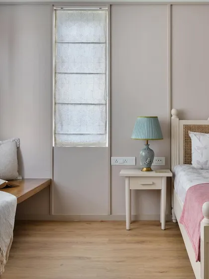 This bedroom from the 'House of Kismish' project has a French-inspired feel, with a custom study desk that transitions into a charming window seat, adding both function and elegance.