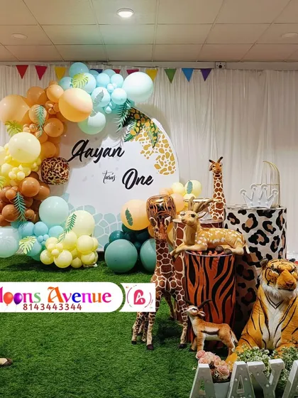 This view shows the arrangement of animal props and themed pedestals for Aayan's first birthday party.