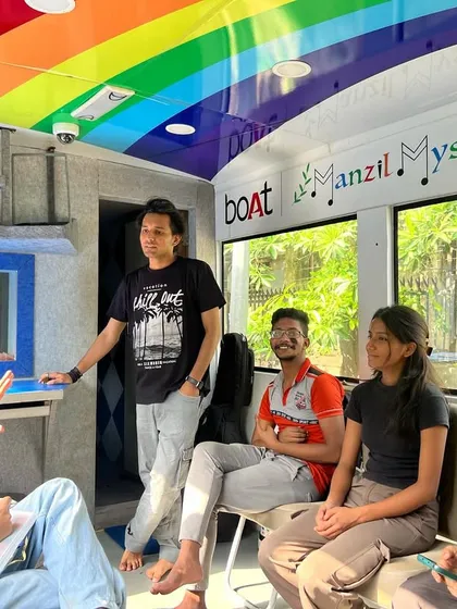 Inside the bus, facilitators explain the recording process to our Kala-Car students. The interior is designed to be a comfortable and inspiring space for learning, collaboration, and creation.