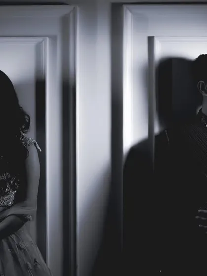 A creative black and white shot of the couple, using shadows and separation to create an artistic and emotional portrait.