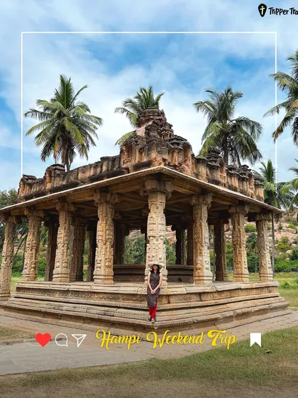 A woman poses in front of a historic temple in Hampi. The ancient ruins provide a stunning and unique backdrop for your travel photos.