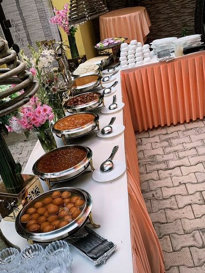 A close-up of a bountiful buffet line, featuring a variety of main courses and our popular Gulab Jamun for dessert.