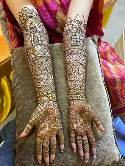 For this bride, I created a full-arm design featuring a mix of architectural elements, peacock figures, and floral patterns. The result is a rich, detailed tapestry that tells a story from her fingertips to her elbows.