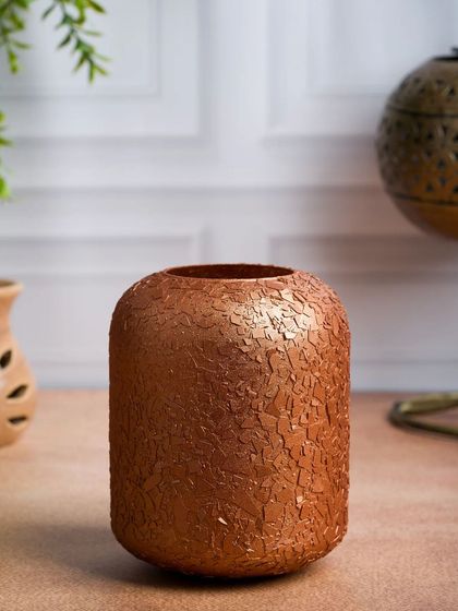 The same textured copper vase, shot empty to better showcase its unique finish. We provide both styled and unstyled shots for our clients.