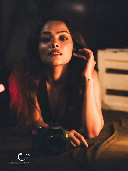 A soft and alluring gaze. The warm, directional light creates a beautiful, intimate mood.