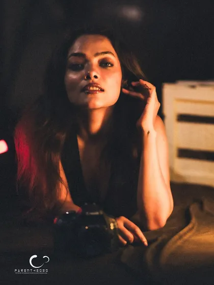 A soft and alluring gaze. The warm, directional light creates a beautiful, intimate mood.