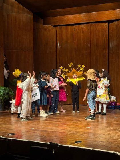 A whimsical scene from one of our plays, with students dressed as stars and storybook characters.