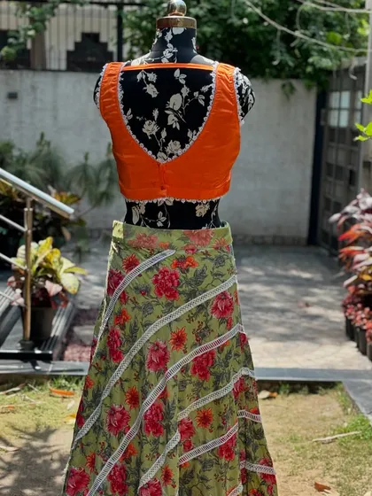 The back of the blouse features a deep cut, adding a modern touch to this colorful lehenga.