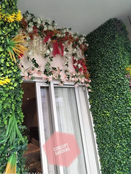 A close-up of our floral canopy work over a balcony door. We use a mix of artificial flowers and vines, like bougainvillea and wisteria, to create a romantic and colorful entrance.