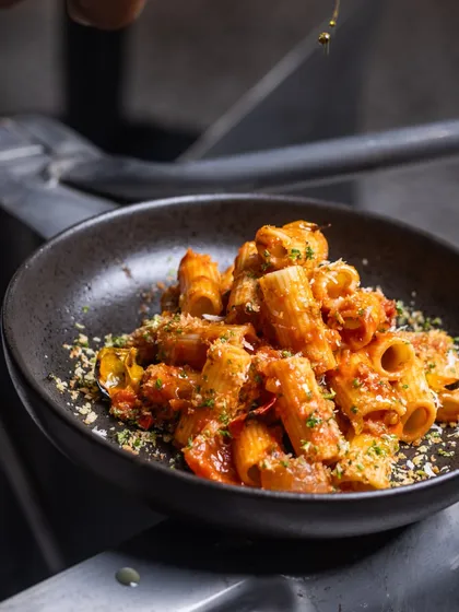 A bowl of my Rigatoni pasta, ready to be enjoyed. The tube-shaped pasta is perfect for catching the rich and flavorful Arrabbiata sauce.