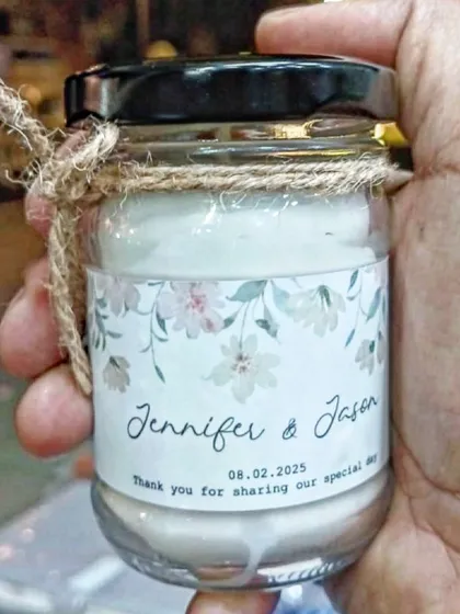 A close-up of a scented jar candle I made as a wedding favor. I can print your names, wedding date, and a thank you message on a custom label, making it a memorable return gift for your guests.