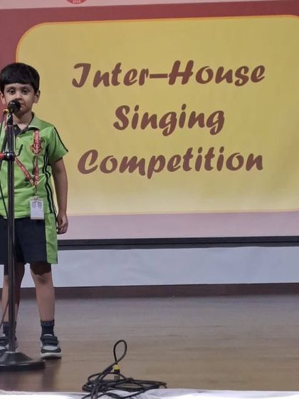 A student from the pre-primary wing participates in the Inter-House Singing Competition, showing that talent is nurtured from a very young age at our school.