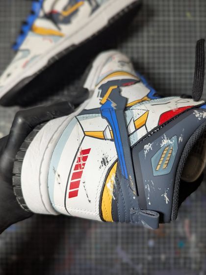 A close-up shot of the battle-damaged Strike Freedom Gundam custom. The scuffs and paint splatters are all hand-painted to create a realistic, weathered effect.
