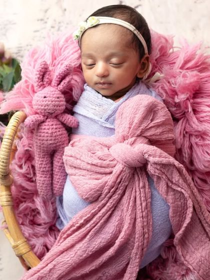 Even the tiniest dolls can join the fun. This newborn is captured sleeping peacefully in a miniature bed within the Barbie dream world setup.