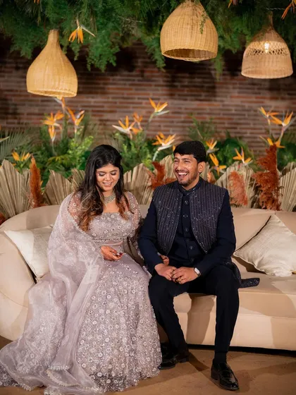 A candid moment of laughter between Yeshaswini and Shashank. We designed a boho-chic backdrop with cane lanterns and birds of paradise that perfectly matched their relaxed and happy vibe.
