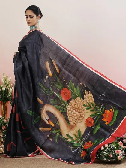 The side view of the swan-printed saree, showing the elegant drape and the artistic design.