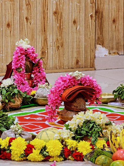 The beautifully decorated Kalasha and offerings for the Rathasaptami puja, adorned with fresh flowers and fruits.