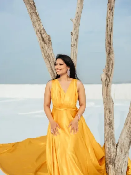 Our yellow trail gown is perfect for both couple shots and solo portraits. Here, the bride-to-be shines in a beautiful portrait, with the long train elegantly draped around her.