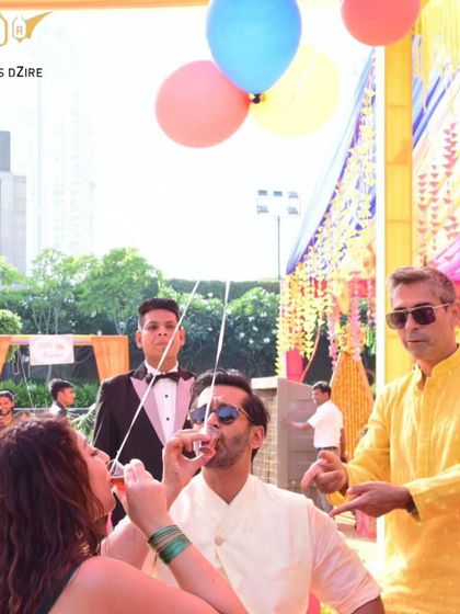 A fun way to welcome guests at a Haldi ceremony. We serve "air balloon shots," where guests drink together from shots attached to balloons, creating a playful and interactive moment.