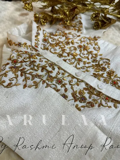 A traditional Jubba and Kacche set for a tiny toddler. The off-white raw silk is adorned with delicate gold hand embroidery on the chest.