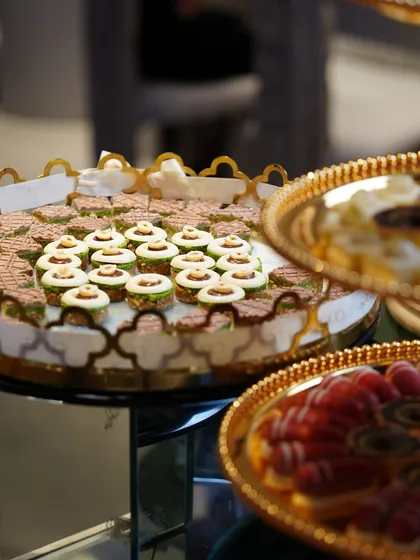 Golden trays laden with a variety of our finest Indian and Western sweets, a testament to our diverse pastry offerings.
